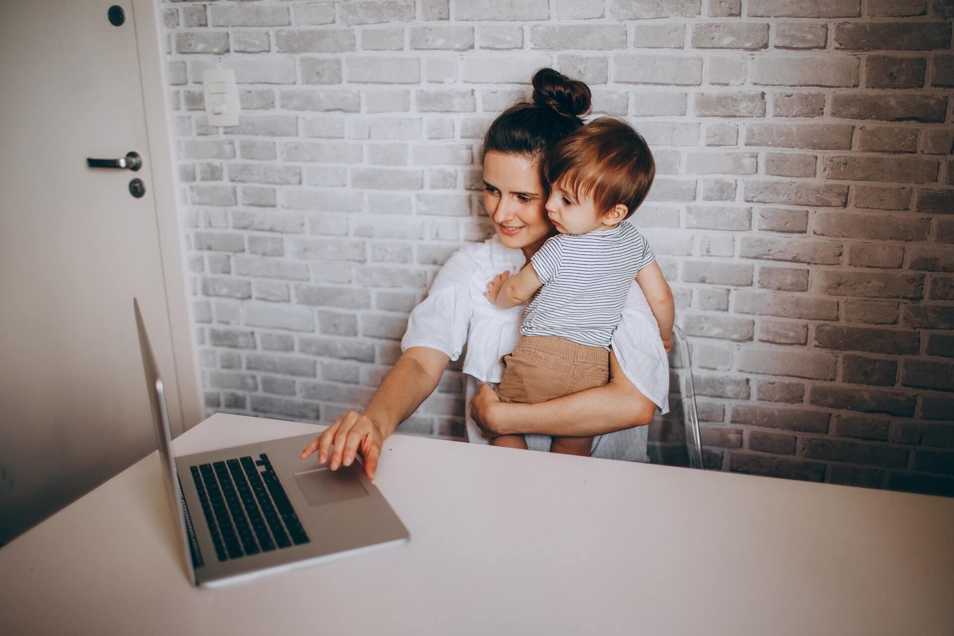 Person working remotely on a laptop looking out a window