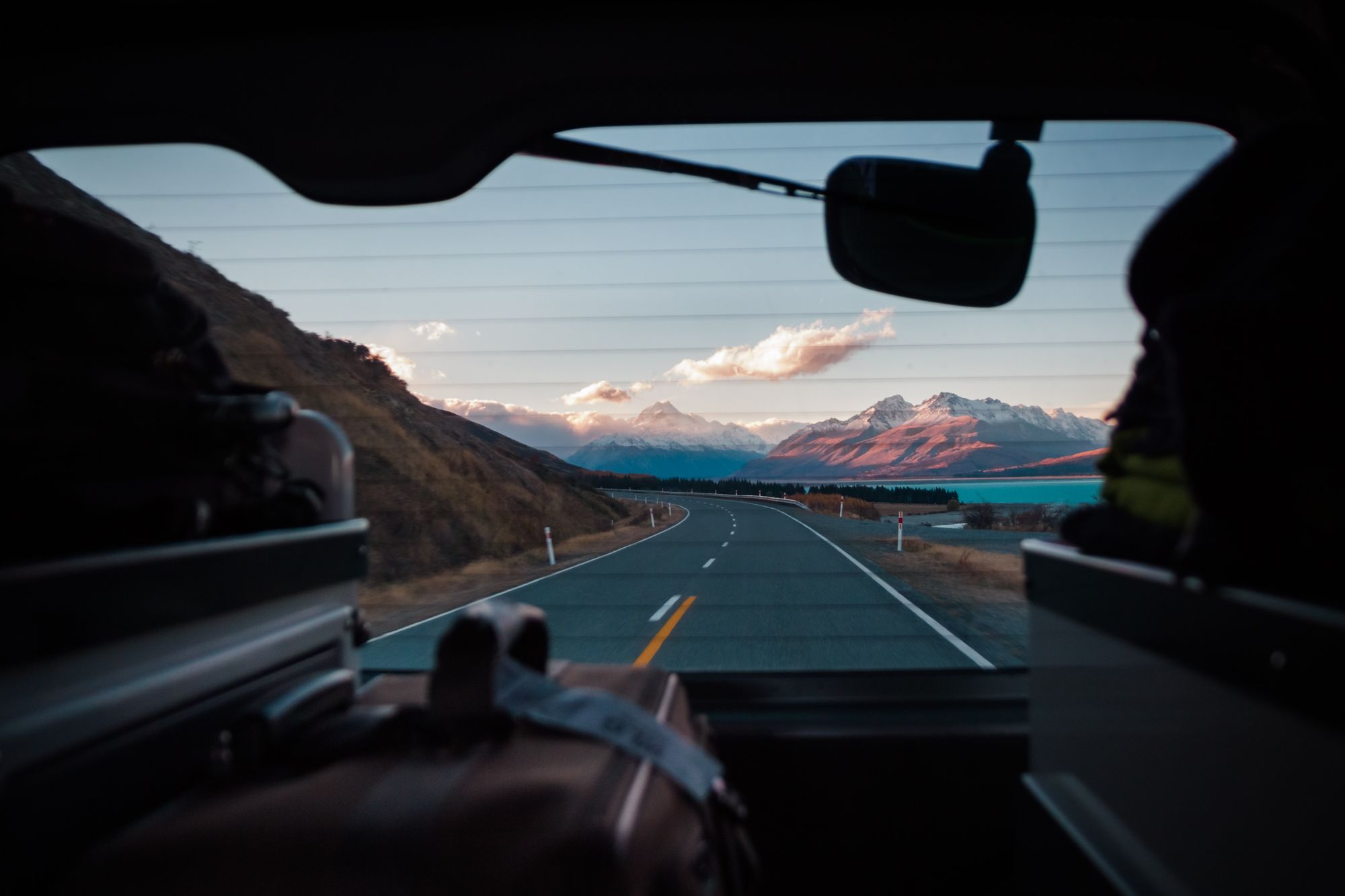 suitcases and a view out the back window of the car