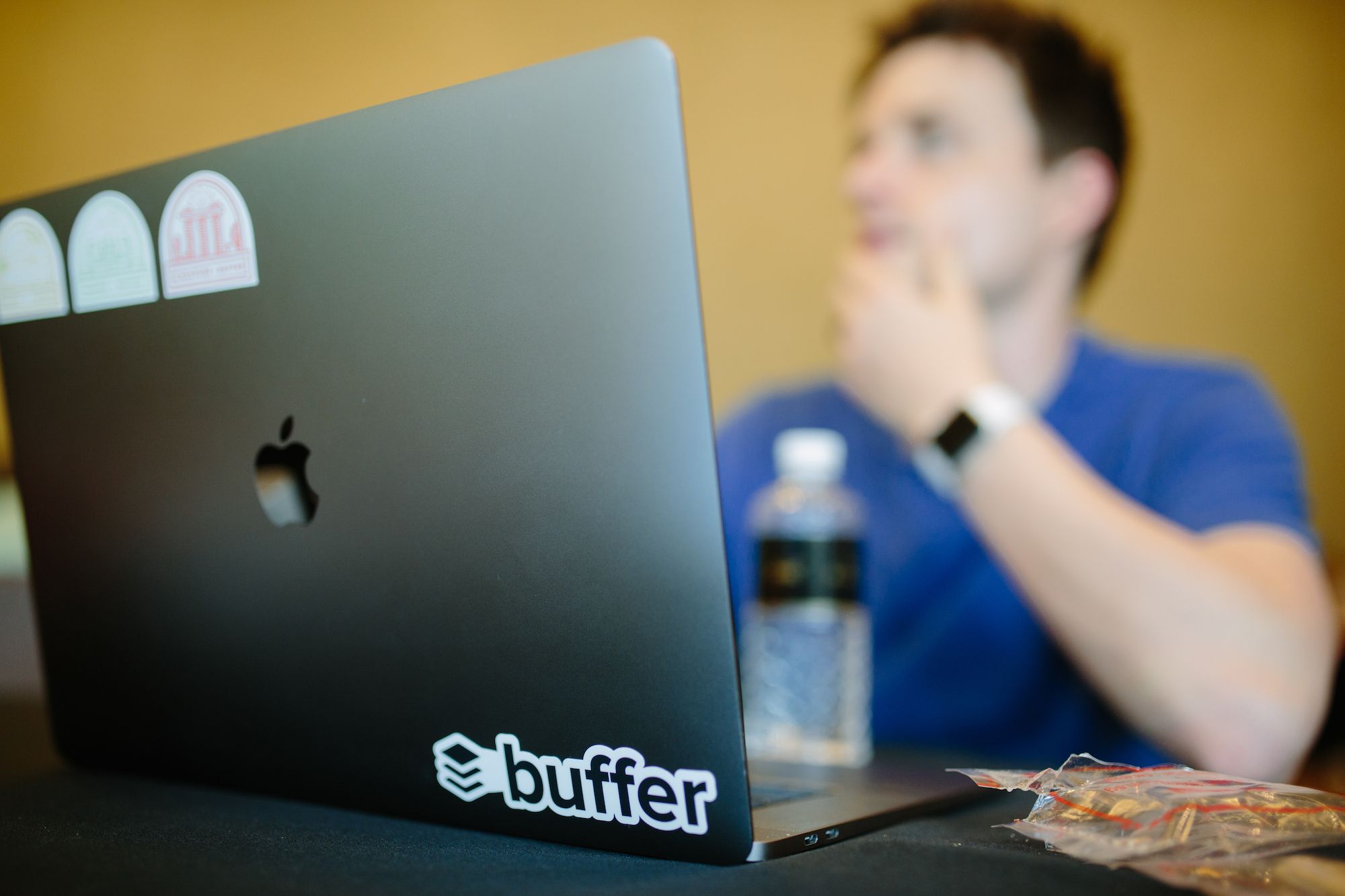An image of a laptop with a Buffer sticker on it.