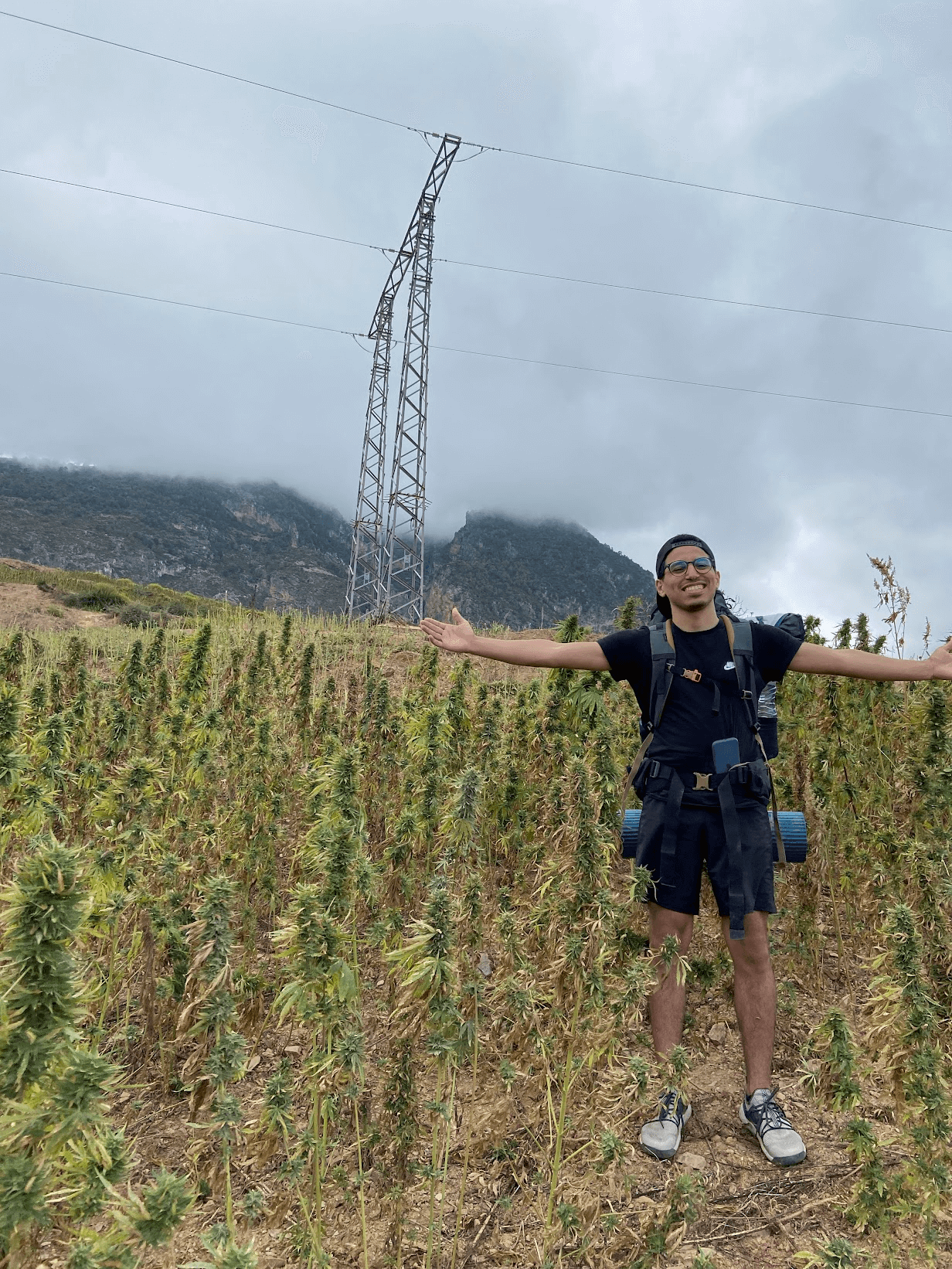 An image of Ismail standing in a hashish farm in Morocco