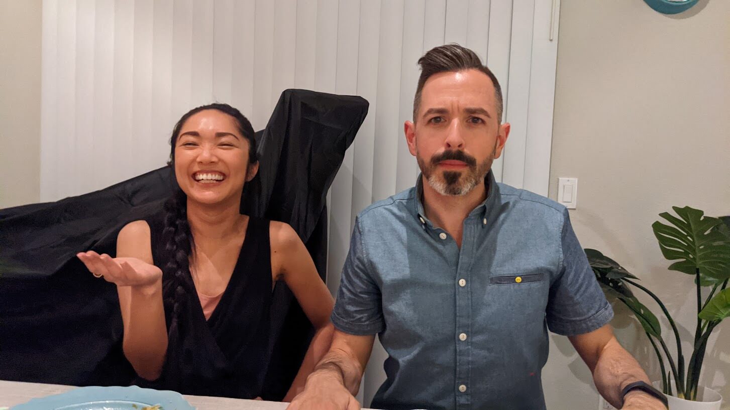 Two individuals sitting next to each other at a dinner table