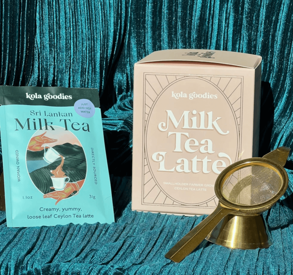 A tea box packet and a golden tea strainer