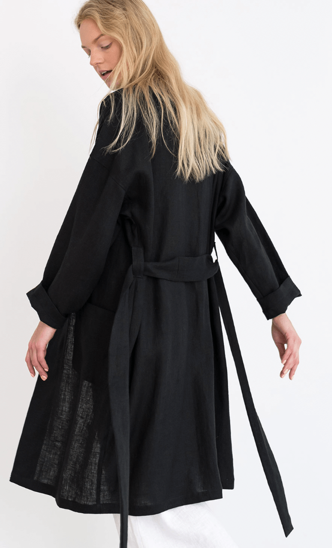 A woman in a long black coat.