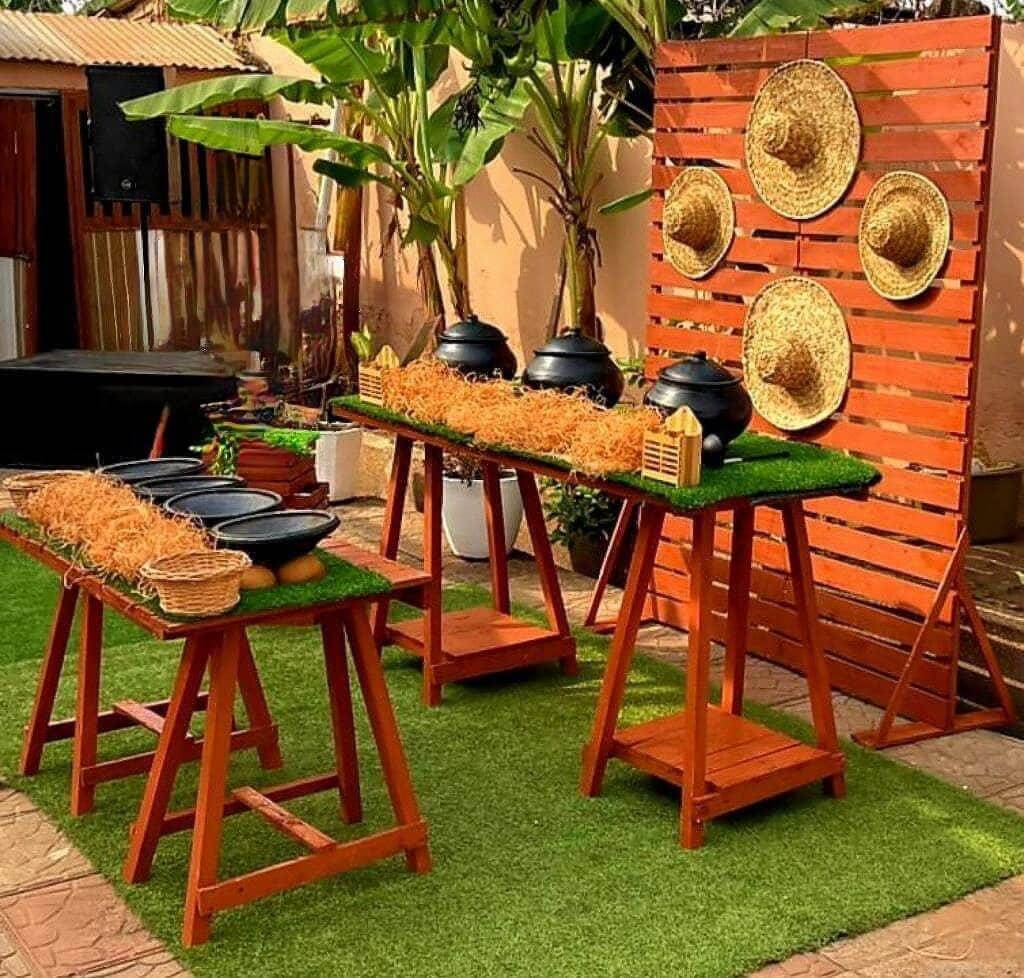 A local snacks/drinks bar setup at a Ghanaian wedding, with local earthenware bowls, pots and straw hats.