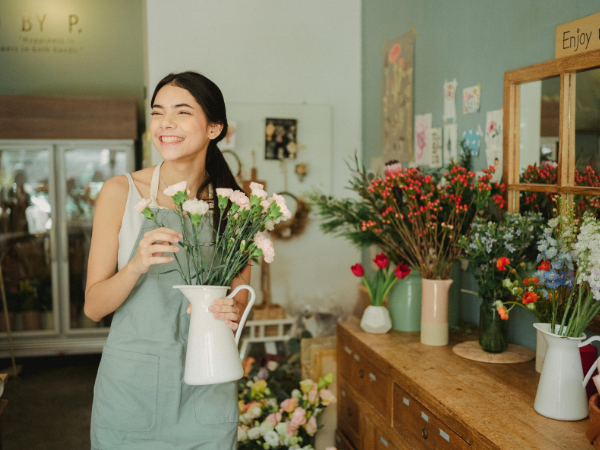 A young female business owner in her flower shop to illustrate running successful Instagram ads