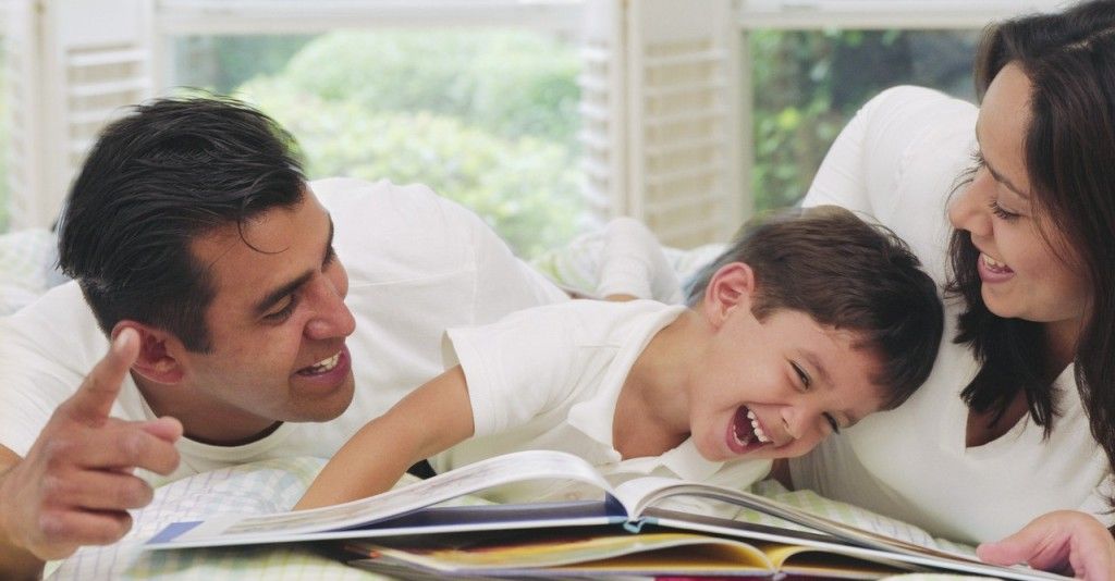 Parents Reading to Laughing Boy