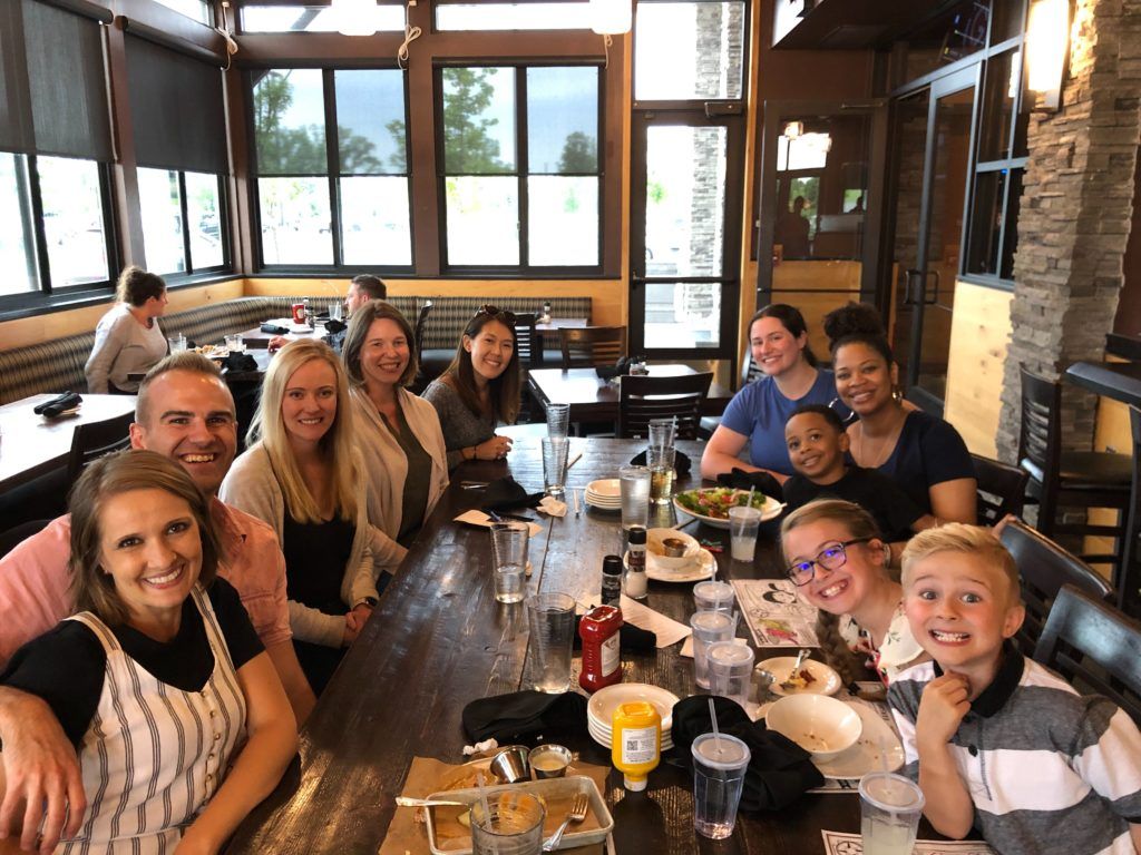 A group of Buffer teammates seated at dinner with three children of teammates